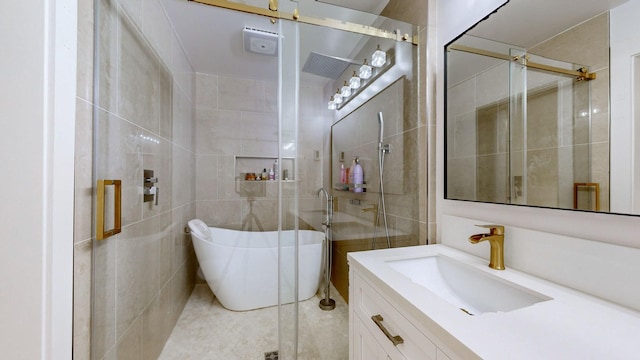 bathroom featuring tile patterned flooring, vanity, and shower with separate bathtub