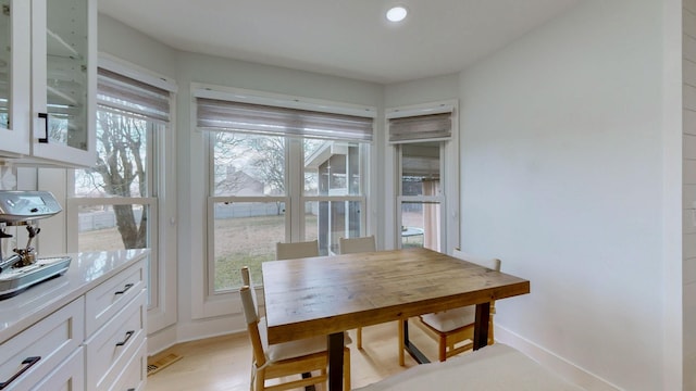 dining space featuring plenty of natural light and light hardwood / wood-style floors