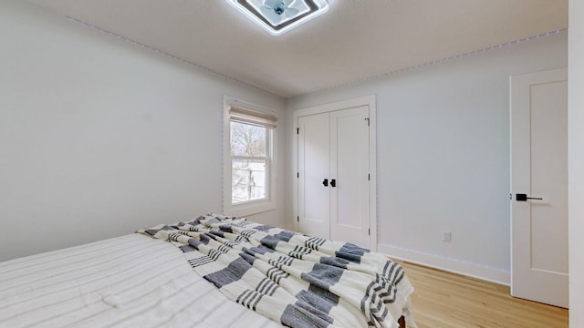 bedroom featuring light wood-type flooring and a closet