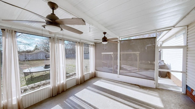 unfurnished sunroom with ceiling fan and lofted ceiling