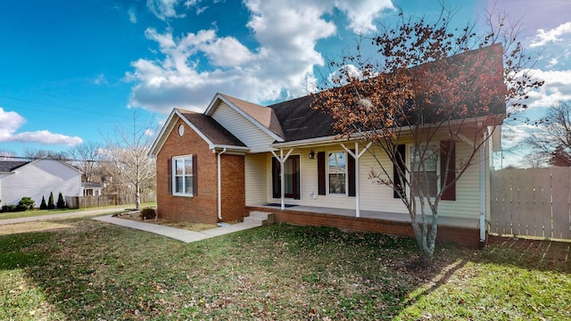 view of front of home featuring covered porch and a front yard