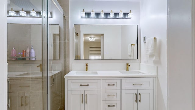 bathroom featuring vanity and a shower with door