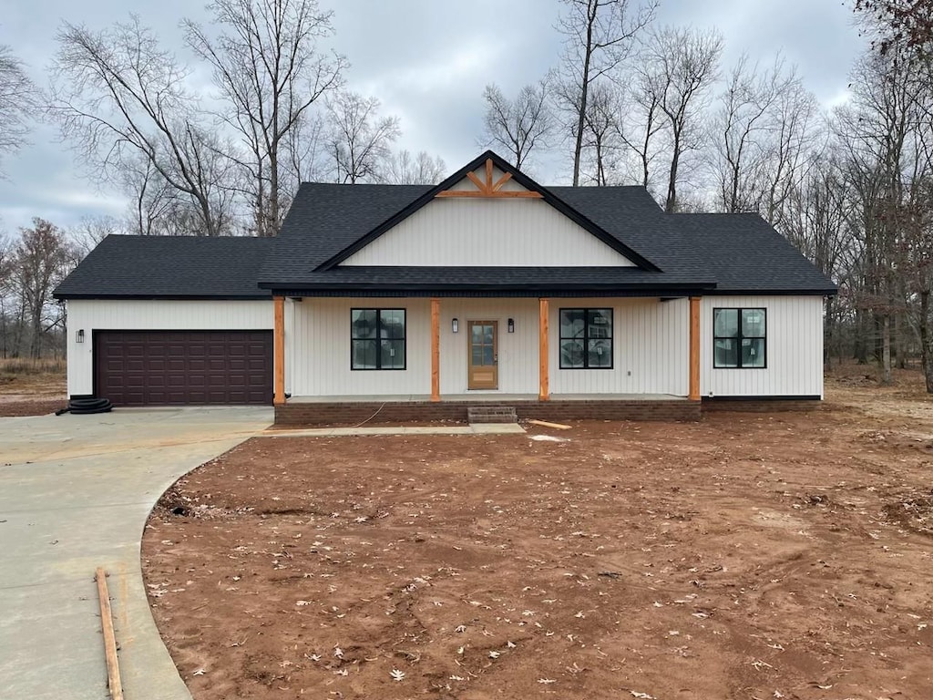 modern farmhouse style home with a porch and a garage