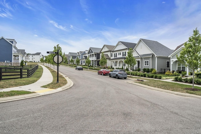 view of street featuring curbs, sidewalks, and a residential view