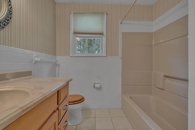 full bathroom featuring vanity, tile patterned flooring, toilet, shower / bathing tub combination, and tile walls