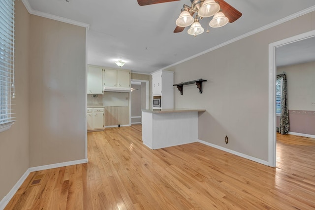 unfurnished living room with ceiling fan, light hardwood / wood-style flooring, and ornamental molding