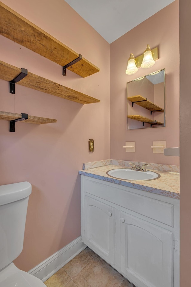 bathroom featuring tile patterned flooring, vanity, and toilet