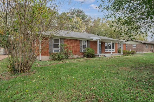 ranch-style home with covered porch and a front yard