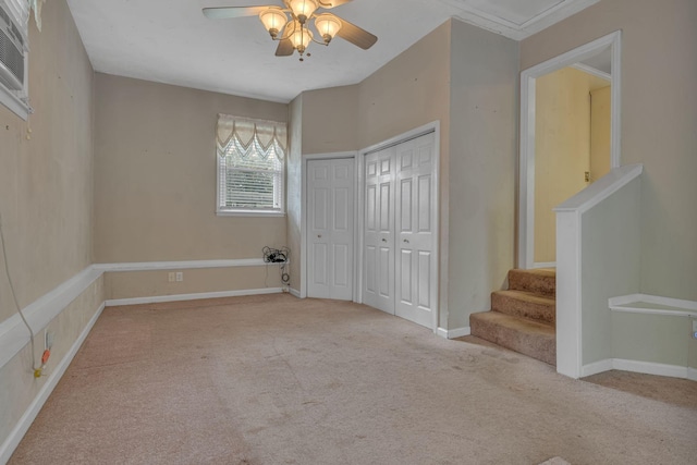 unfurnished bedroom featuring light carpet and ceiling fan