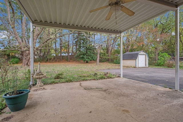 view of patio / terrace featuring ceiling fan and an outbuilding