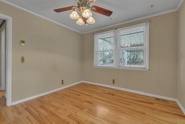 empty room with crown molding, ceiling fan, and light hardwood / wood-style floors