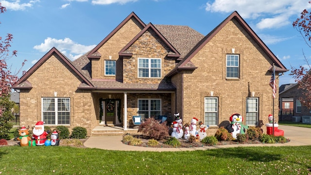 view of front facade with central air condition unit and a front lawn