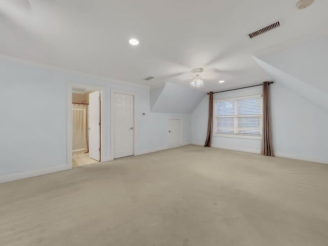 bonus room featuring light carpet, ceiling fan, and vaulted ceiling