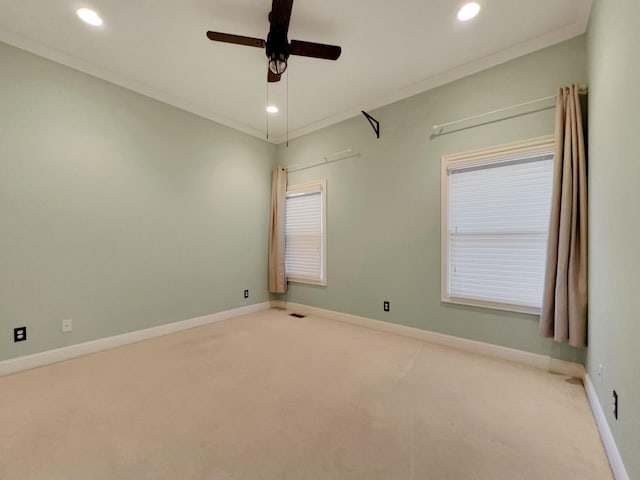 spare room featuring carpet floors, ceiling fan, and ornamental molding