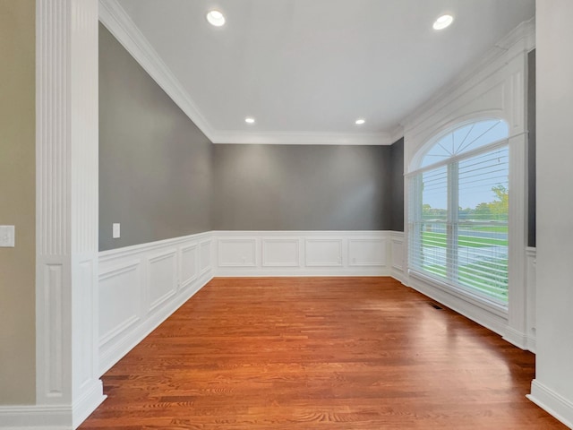 spare room with hardwood / wood-style flooring and ornamental molding