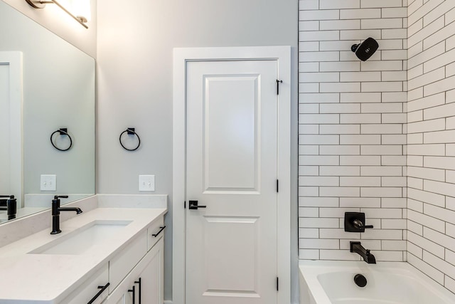 bathroom featuring vanity and tiled shower / bath combo