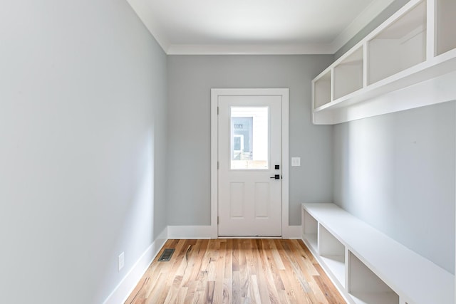 mudroom with light hardwood / wood-style floors and crown molding