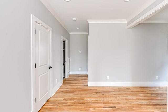 unfurnished room featuring light hardwood / wood-style floors and ornamental molding