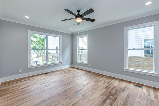 spare room featuring ceiling fan, light wood-type flooring, and ornamental molding