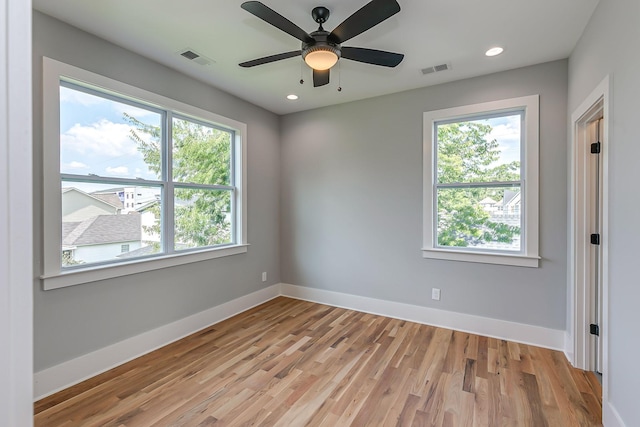 unfurnished room with ceiling fan and light wood-type flooring