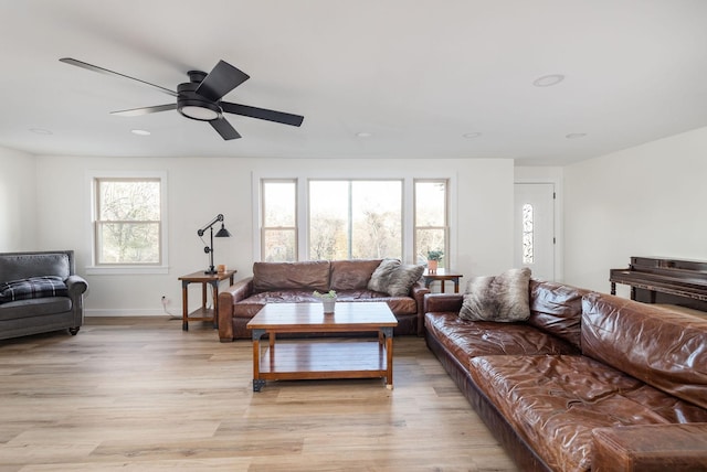 living room with ceiling fan and light hardwood / wood-style flooring