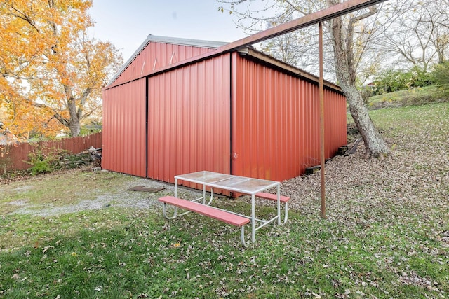 view of outbuilding with a yard