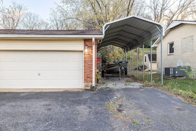 view of parking / parking lot with a carport and a garage