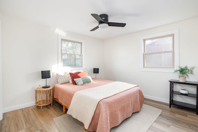 bedroom with ceiling fan and light hardwood / wood-style flooring