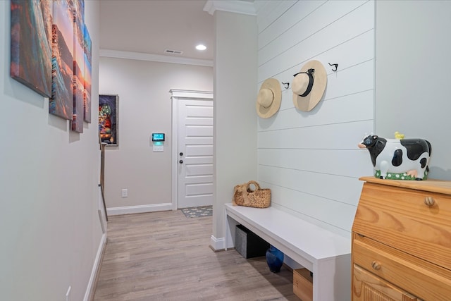 mudroom with light hardwood / wood-style floors and ornamental molding