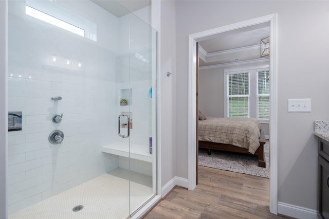 bathroom featuring hardwood / wood-style floors, a shower with door, plenty of natural light, and crown molding