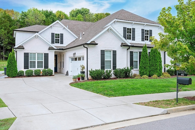 view of front of house featuring a front lawn and a garage