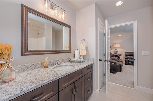 bathroom with tile patterned floors, vanity, and walk in shower