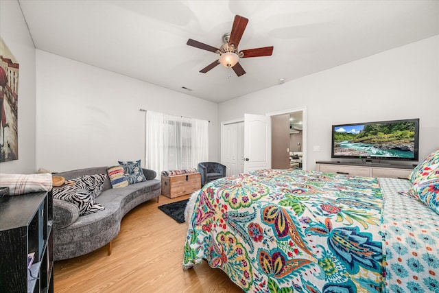 bedroom with ceiling fan, a closet, and light hardwood / wood-style floors