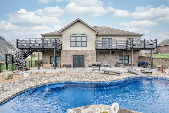 back of house with a pool side deck and a patio area