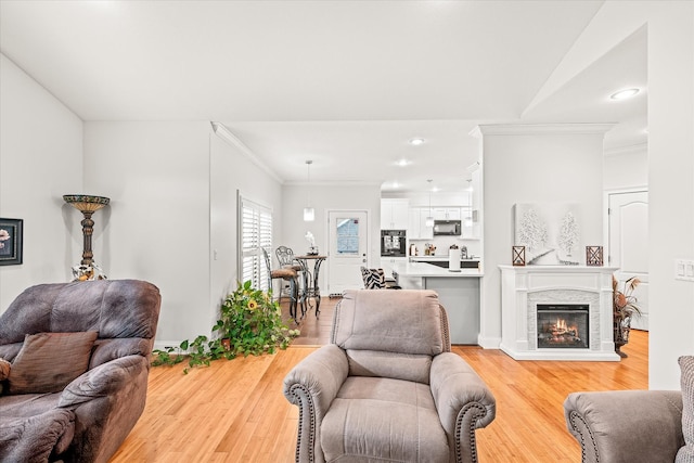 living room with hardwood / wood-style floors and crown molding