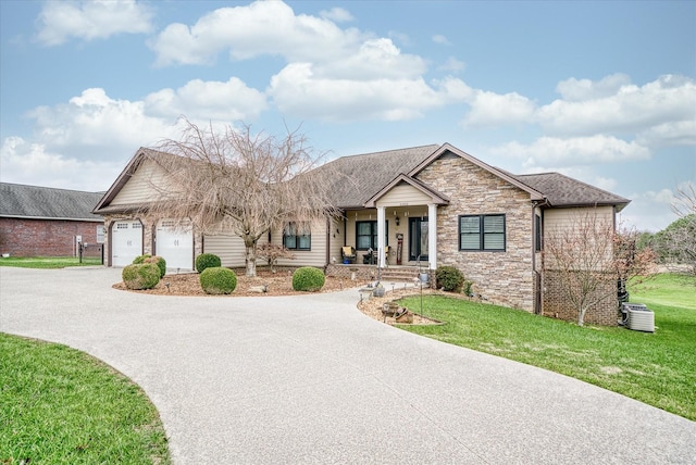 view of front of home with a porch, a garage, and a front lawn