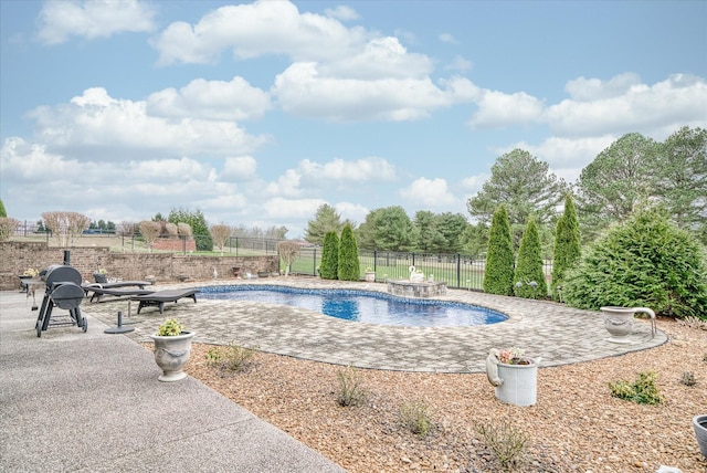 view of swimming pool with pool water feature and a patio