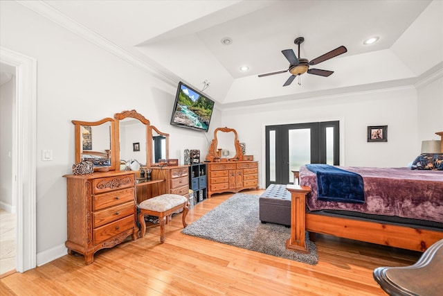 bedroom with wood-type flooring, a tray ceiling, ceiling fan, and crown molding