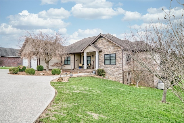 view of front facade with a front yard, a porch, and a garage