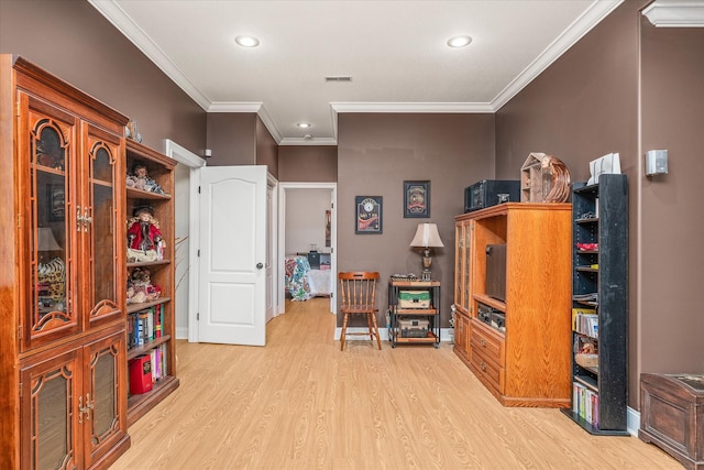 game room with light hardwood / wood-style floors and crown molding