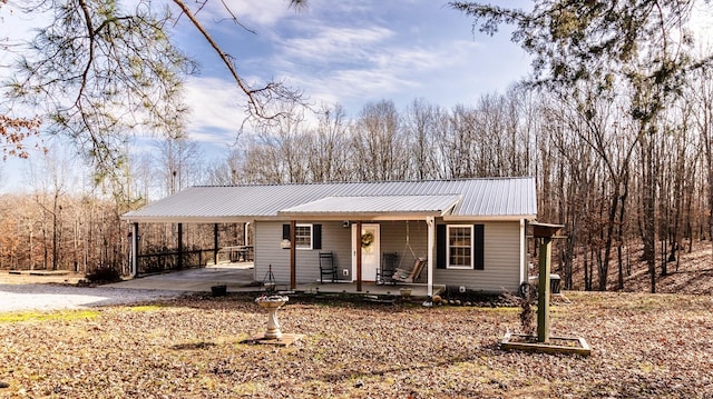 view of front of home featuring covered porch and a carport