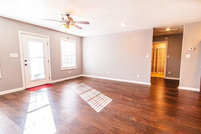 spare room featuring ceiling fan and dark wood-type flooring