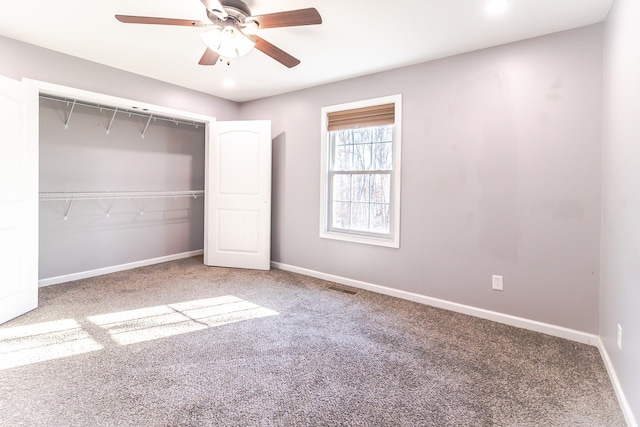 unfurnished bedroom featuring carpet, a closet, and ceiling fan