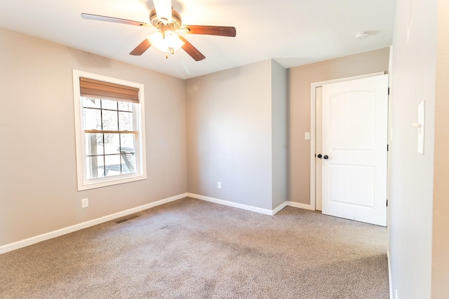 empty room featuring light carpet and ceiling fan