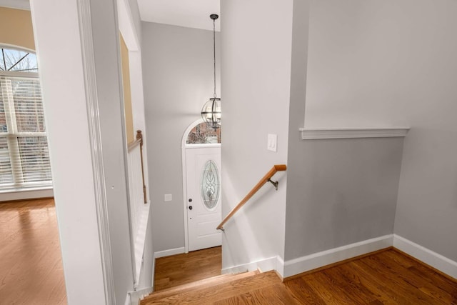 entrance foyer with wood-type flooring and a notable chandelier