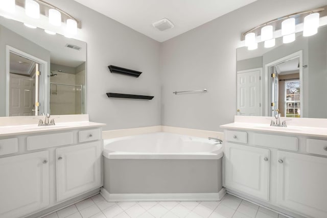 bathroom with vanity and shower with separate bathtub