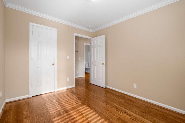 unfurnished bedroom with wood-type flooring and ornamental molding