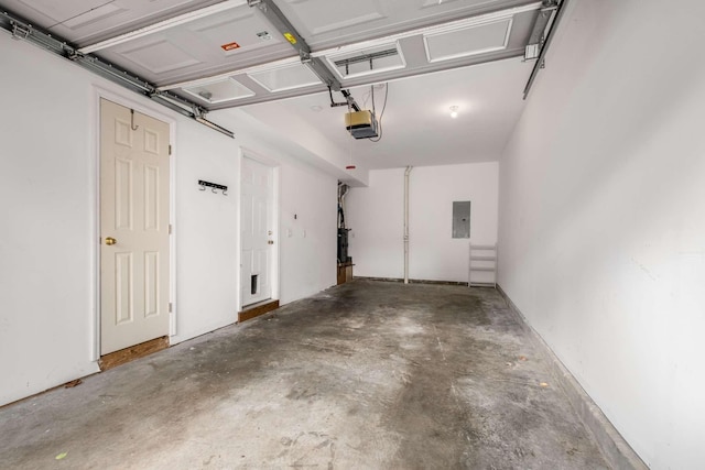 garage featuring a garage door opener and electric panel