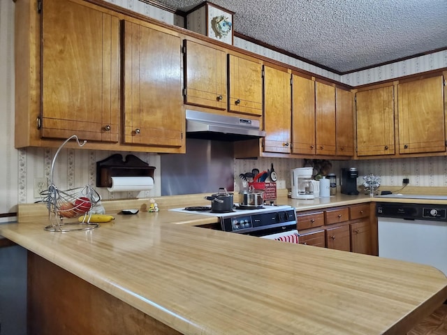 kitchen featuring a textured ceiling, white appliances, and kitchen peninsula