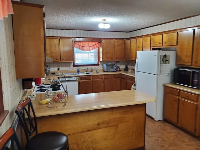 kitchen with kitchen peninsula, a textured ceiling, white appliances, and light parquet floors